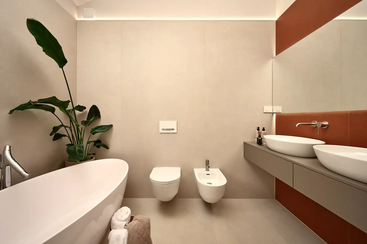 A bathroom with a freestanding bath and terracotta tiles