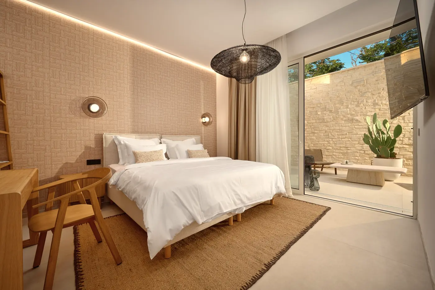 A bedroom with a sliding door to its own walled courtyard